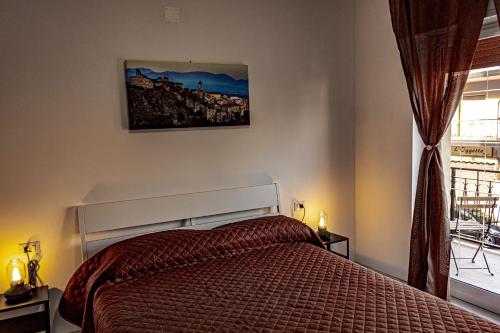 a bedroom with a bed and a window at Bed end Breakfast Mediterraneo in Scalea