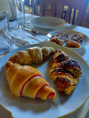 a plate of food with pastries and bread on a table at Antica Taverna del Principe in Sepino