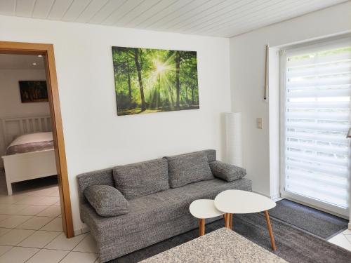 a living room with a couch and a table at Ferienwohnung Waldblick Teutoburger Wald in Oerlinghausen