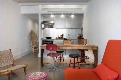 a kitchen with a wooden table and some chairs at Best House Best Place in Barcelona