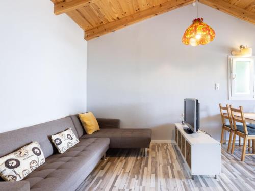 a living room with a couch and a tv at Holiday Home Jorge by Interhome in Zamorano