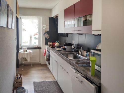 a kitchen with a sink and a counter top at Apartment Allod Park Haus C 207 by Interhome in Davos