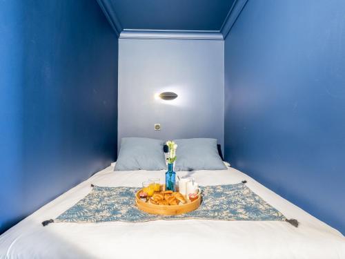 Cette chambre bleue comprend un lit avec un bol de fruits. dans l'établissement Studio Le Britannia-3 by Interhome, à Carnac