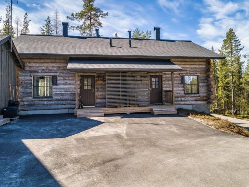 a log cabin with a driveway in front of it at Holiday Home Taruilevi 8 h2 by Interhome in Sirkka
