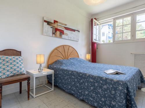 a bedroom with a bed and a table and a chair at Holiday Home Chemin de l'Empereur by Interhome in Guéthary