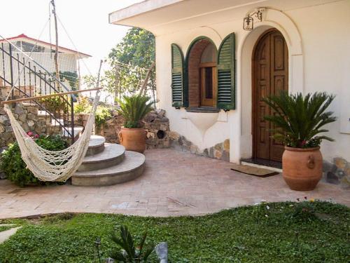 een veranda van een huis met een hangmat ervoor bij Holiday Home Path of the Gods by Interhome in Vettica Maggiore