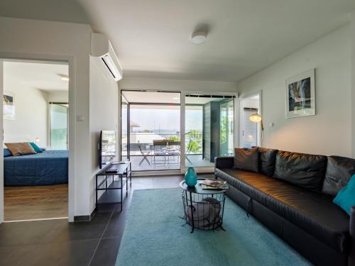 a living room with a couch and a table at Apartment Fűzfő by Interhome in Balatonszemes