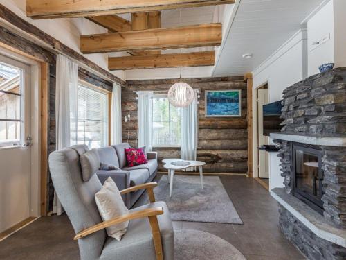 a living room with a couch and a fireplace at Holiday Home Taruilevi 8 h3 by Interhome in Levi
