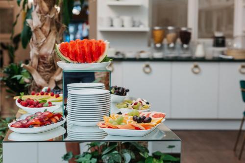 a buffet of fruits and vegetables on a table at Hotel Jan in Krakow