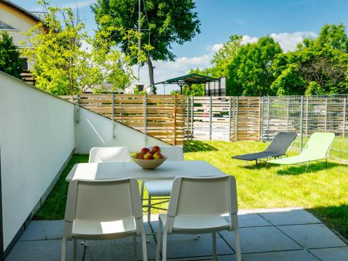 a patio with a table and chairs in a yard at Apartment Földvár by Interhome in Balatonszemes