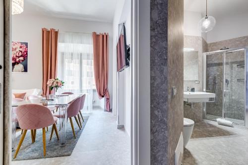 a room with a dining table and a bathroom at Trevi Fountain - NEW! - Your Italian Holidays in Rome