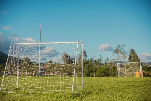 a soccer field with a net in the grass at Hotel Reserva Campestre LA CABAÑA GLAMPING in Duitama