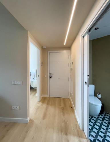an empty bathroom with a toilet and a door at Barcelona Touch Apartments - Progres in Hospitalet de Llobregat