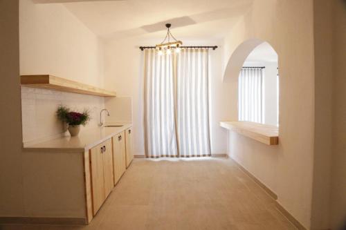 a kitchen with a long hallway with a window at Villa myra in Demre
