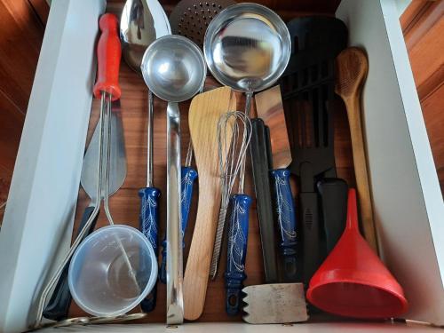 a drawer filled with kitchen utensils and spatulas at V přírodě na okraji Frenštátu pod Radhoštěm in Frenštát pod Radhoštěm