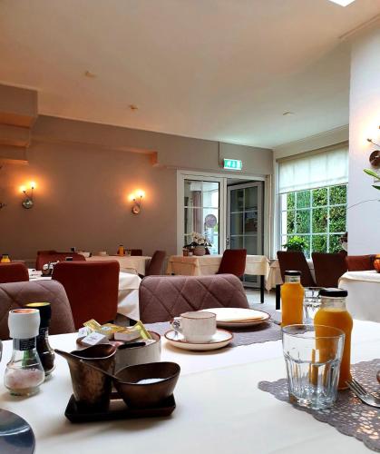 a living room with a table with food on it at Hotel Pension Oranje in Valkenburg