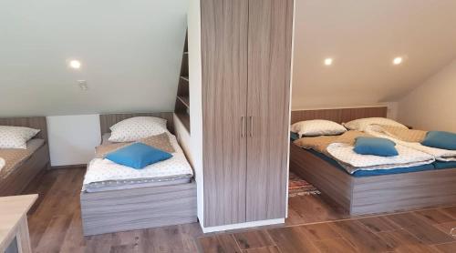 two twin beds in a room with mirrors at Apartma Cifra Begunje in Begunje na Gorenjskem