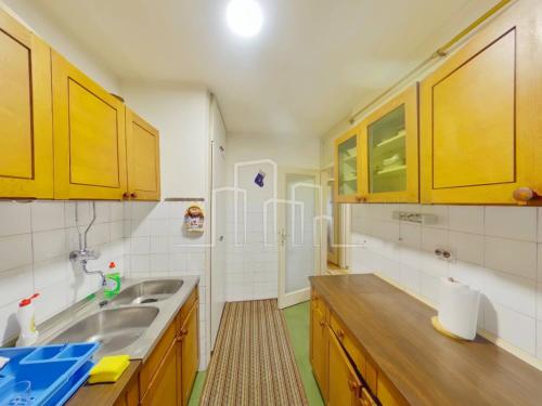 a kitchen with yellow cabinets and a sink at Apartment Ciglane - Pet friendly in Sarajevo