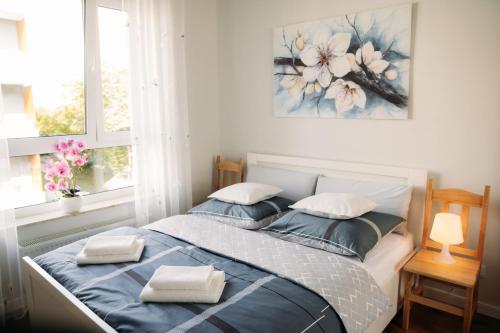 a bedroom with a bed with two pillows on it at Apartament 15 in Kościerzyna