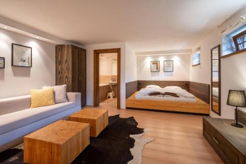 a living room with a bed and a couch at Wellness Drevenica Zuberec in Zuberec