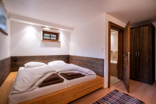a bedroom with a wooden bed in a room at Wellness Drevenica Zuberec in Zuberec