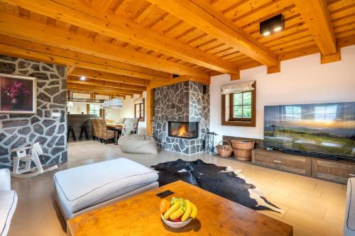 a living room with a fireplace and a table at Wellness Drevenica Zuberec in Zuberec