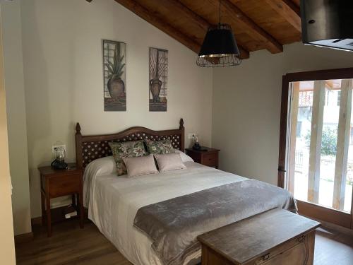 a bedroom with a large bed and a window at LA CASINA DE PAULA in Ríoseco