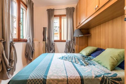 a bedroom with a bed with a blue comforter at enJoy Home - Appartamento a due passi dal Teatro Verdi in Padova
