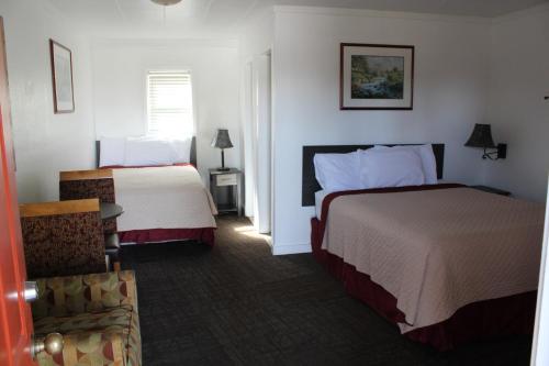 Postel nebo postele na pokoji v ubytování Chalet Motel