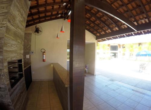 a hallway of a house with a kitchen and a patio at Cegil Hotel Boulevard in Resende