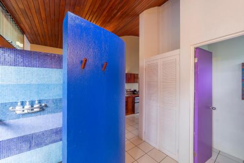 a bathroom with blue walls and a blue shower curtain at Xandari Resort & Spa in Alajuela