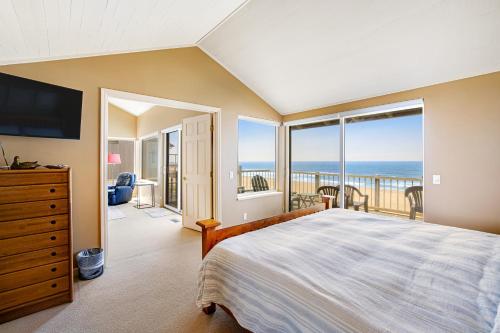 a bedroom with a bed and a view of the ocean at Searidge D2 in Depoe Bay