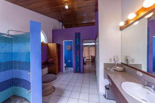 a bathroom with a sink and a toilet at Xandari Resort & Spa in Alajuela City