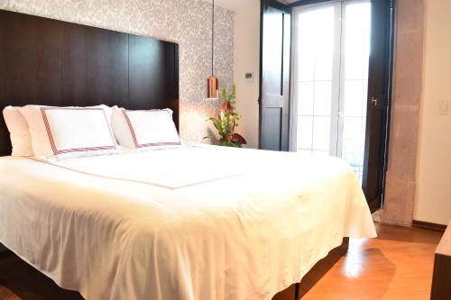 Ένα ή περισσότερα κρεβάτια σε δωμάτιο στο Santa Rita Hotel del Arte
