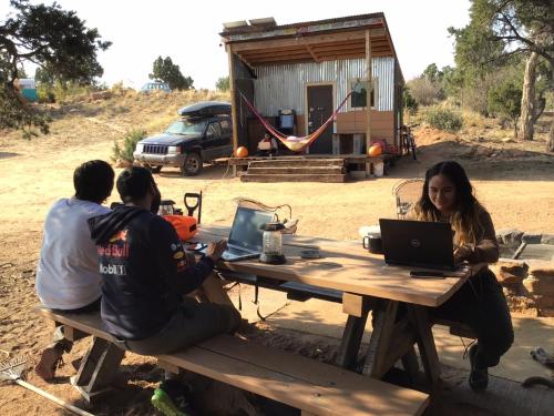 a group of people sitting at a picnic table with a laptop at Indian Canyon Ranch in Verdure