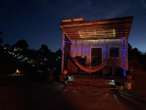 a small building with a hammock outside at night at Indian Canyon Ranch in Verdure