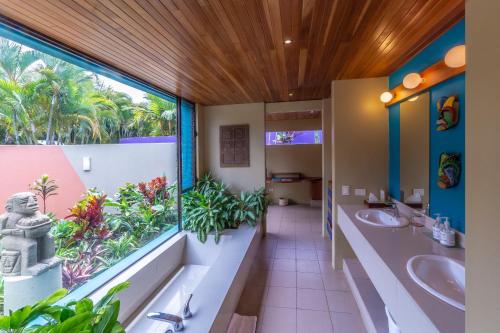 a bathroom with two sinks and a large window at Xandari Resort & Spa in Alajuela City