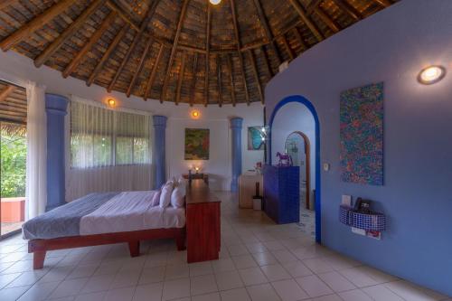 a bedroom with a bed and a wooden ceiling at Xandari Resort & Spa in Alajuela City