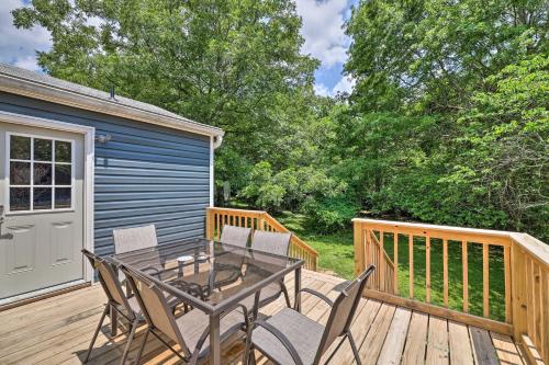 a patio with a table and chairs on a deck at Updated Fayetteville Home Less Than 2 Miles to UArk! in Fayetteville