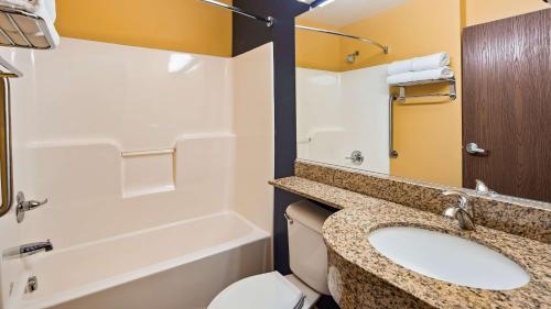 a bathroom with a sink and a toilet at SureStay Plus Hotel by Best Western Keyser in Keyser