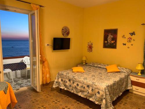 a bedroom with a bed and a view of the ocean at Appartamenti Tina in Villa Restituta in Ischia