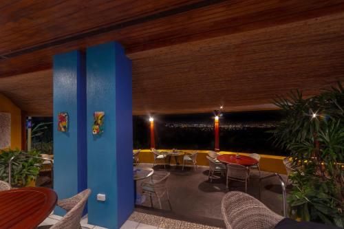 a patio with tables and chairs in a restaurant at Xandari Resort & Spa in Alajuela City
