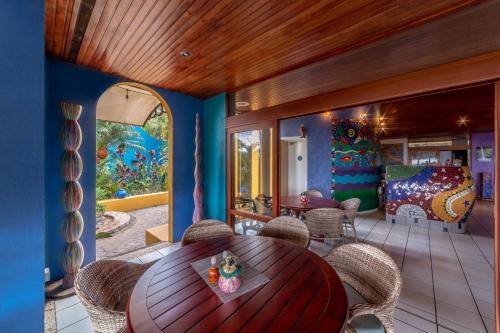 a dining room with a wooden table and chairs at Xandari Resort & Spa in Alajuela City