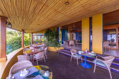 a restaurant with tables and chairs on a balcony at Xandari Resort & Spa in Alajuela City