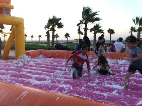 a group of people playing in an inflatable water park at porto said بورتوسعيد in `Ezbet Shalabi el-Rûdi