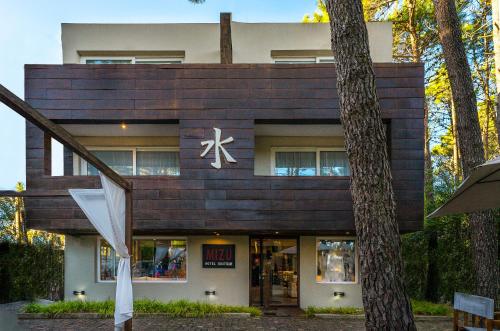 a building with a sign on the front of it at Mizu Hotel Boutique in Mar de las Pampas