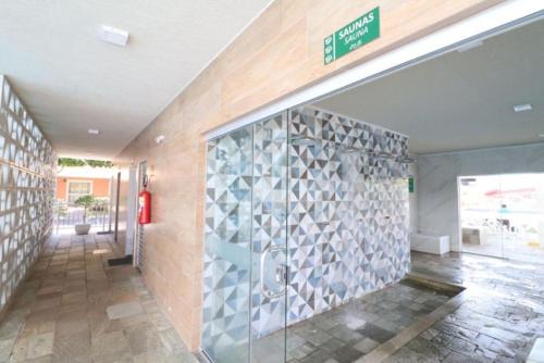 a lobby of a building with a glass door at Fiori Caldas Novas - 245 in Caldas Novas