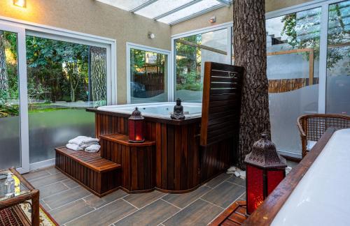 a bathroom with a bath tub and a tree at Mizu Hotel Boutique in Mar de las Pampas