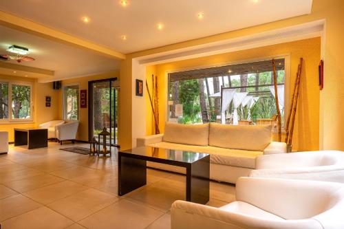 a living room with white furniture and a table at Mizu Hotel Boutique in Mar de las Pampas