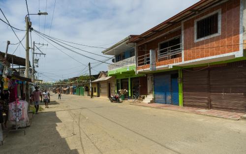 an empty street in a town with buildings at Hotel Clau in Nuquí